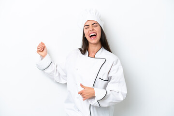 Young chef woman over white background making guitar gesture