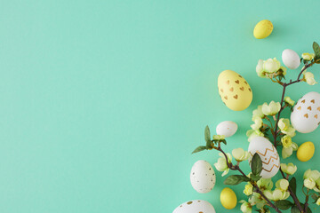 Easter decoration concept. Flat lay photo of colorful easter eggs cherry blossom branch on teal background with empty space
