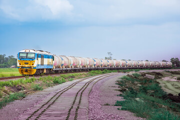 Tanker-freight train by diesel locomotive passed the railway curve.