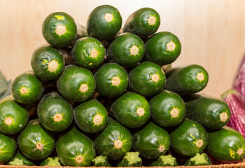 A stack of cucumbers in a wooden box