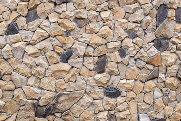 background from big stones Abstract texture of the wall. Coarse beige and gray stone. Stonework.