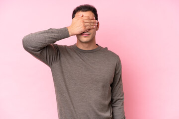 Young caucasian man isolated on pink background covering eyes by hands. Do not want to see something