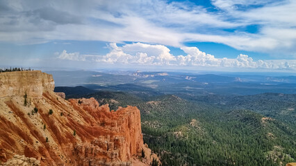Fototapeta premium Scenic aerial view of massive hoodoo sandstone rock formation towers on Navajo trail in Bryce Canyon National Park, Utah, USA. Natural unique amphitheatre in summer. Dark clouds emerging to storm