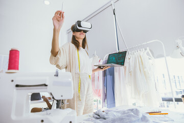 Costume designer using modern VR visual digital design technology in tailor studio