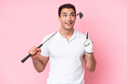 Young golfer player man isolated on pink background thinking an idea pointing the finger up