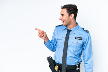 Young police caucasian man isolated on white background pointing finger to the side and presenting...