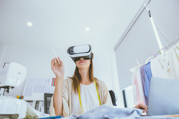 Costume designer using modern VR visual digital design technology in tailor studio