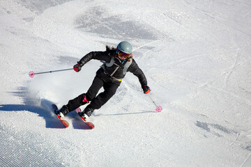 Girl On the Ski. Active winter holidays, skiing downhill in sunny day. Woman skier