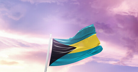 Waving Flag of The Bahamas in Blue Sky. The symbol of the state on wavy cotton fabric.