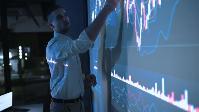 Sharing information. Man in formal clothes is showing business plan on the big projector. Master class.