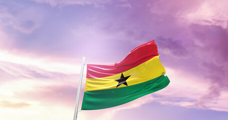 Waving Flag of Ghana in Blue Sky. The symbol of the state on wavy cotton fabric.