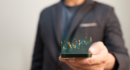trading Forex, bitcoin or stock exchange concept , businessman using mobile phone and internet for investment or financial trading