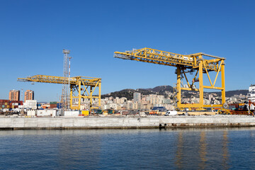GENOA, ITALY, FEBRUARY 2, 2023 - Industrial cranes yellow colour in the port of Genoa, Italy