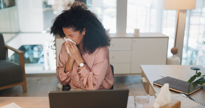 Black woman, covid and sinus in office with sneeze, tissue and runny nose while working on laptop. Business woman, allergies and unwell corporate employee sneezing and suffering flu, cold and allergy