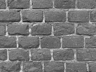 black and white photo of wall made of bricks