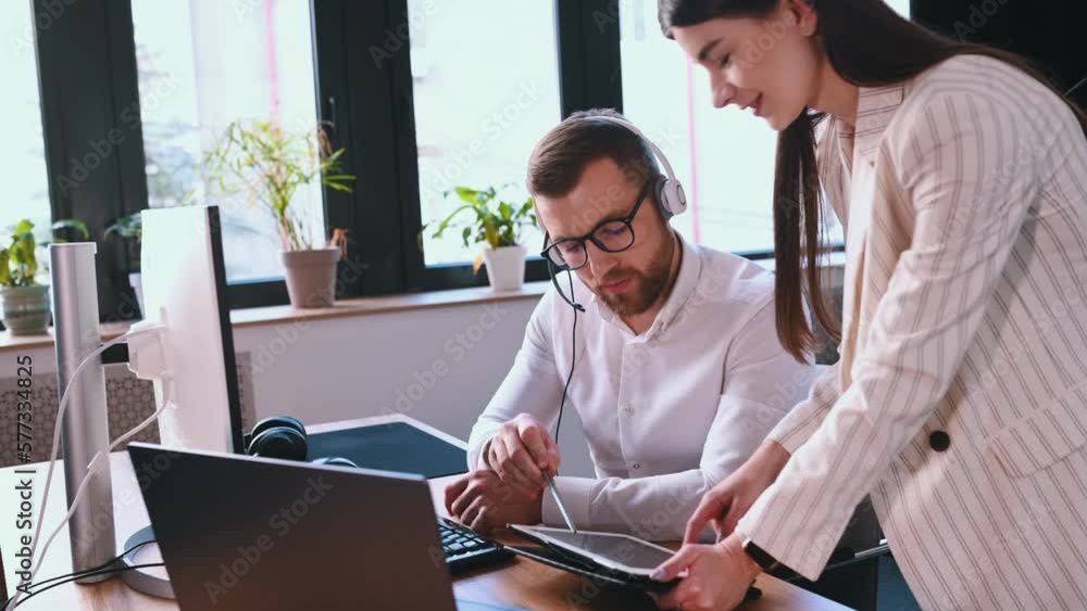 Poster using tablet. man and woman are working together by computer in the office. conception of exchange.