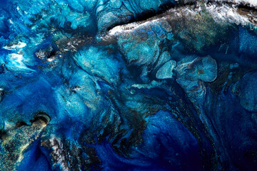 Luxury abstract background, liquid art. Blue alcohol ink with golden paint streaks, water surface, marble texture