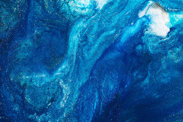 Luxury abstract background, liquid art. Blue alcohol ink with golden paint streaks, water surface, marble texture