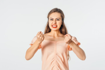 Pissed-off girl gesticulating with her hands, stands over white background. Distressed and...