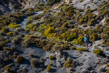 Female hiker hiking the mountains and valleys in the Sierra Nevada mountains in Spain