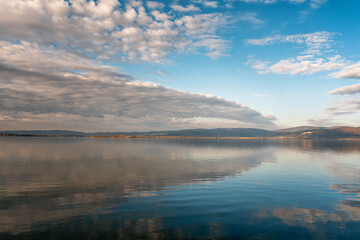 Beautiful landscape with blue sky and white clouds reflected in the surface of the lake