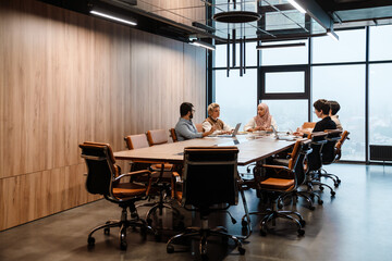 Group of colleagues having discussion during meeting in conference room
