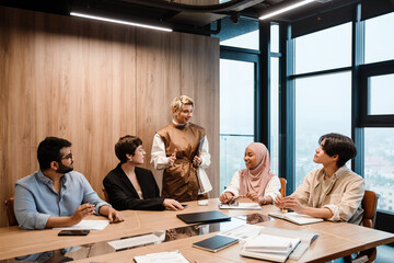 Female manager addressing her team during meeting in conference room