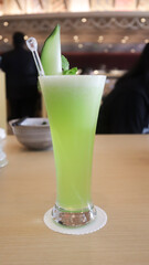 A glass of green melon juice restaurant background, sweet and very refreshing.