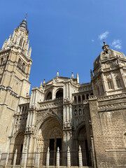 This photo captures the majestic exterior of the Toledo Cathedral, one of the most famous landmarks in Spain. The Gothic architecture is stunning, with intricate details and towering spires