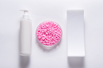 Hot film wax for depilation procedure on white background