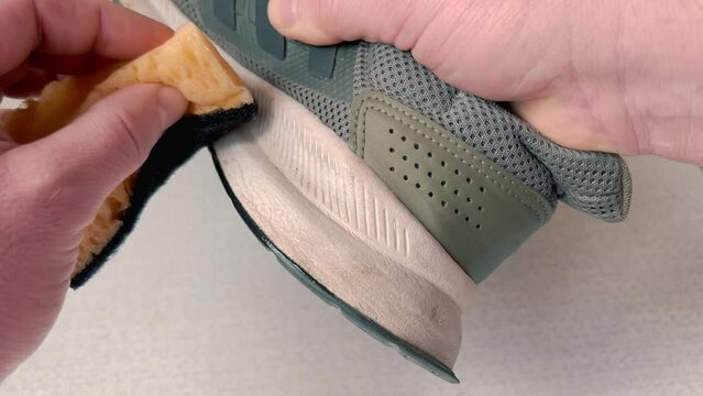 Cleaning and whitening sneakers using a white sole sponge.