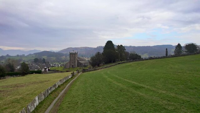 Drone, aerial footage of the historic village of Hawkshead a ancient town in the Lake District, Cumbria. The village is still the same collection of tiny houses, and squares