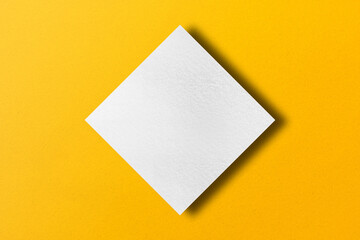 paper cut into square shapes with light and shadow placed on a yellow paper background