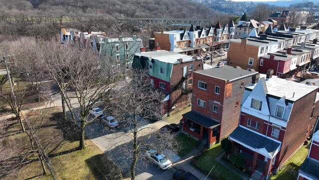 Row houses in city during winter. Oakland Pittsburgh neighborhood for University of Pittsburgh college students. Aerial establishing shot of Pitt housing.