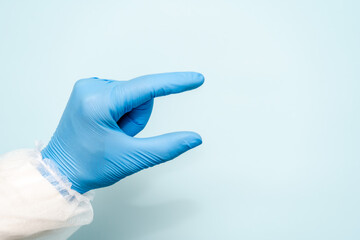 Doctor's hand in blue glove like holding something