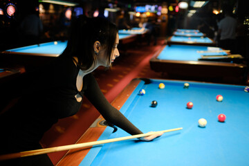 Beautiful woman playing pool