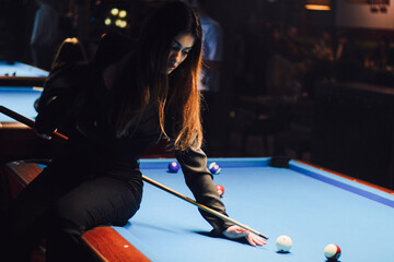 Beautiful woman playing pool