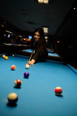 Beautiful woman playing pool