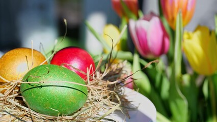 Easter colorful eggs outdoor in sunny warming day with beautiful flowers