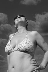 Wspomnienie lata. Portret kobiety w bikini na tle nieba - obrazy, fototapety, plakaty