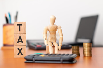 Mastering the art of tax planning: a wooden dummy calculating taxes with a calculator