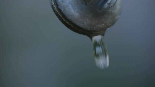 Garden water faucet dripping, closeup