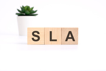 SLA - Service Level Agreement - acronym on wooden cubes on white background. business concept © Maks_Lab