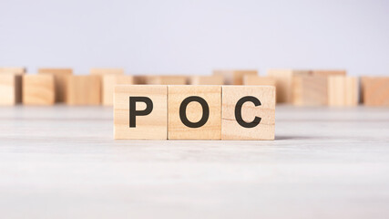 POC - word concept written on wooden cubes or blocks on a light background