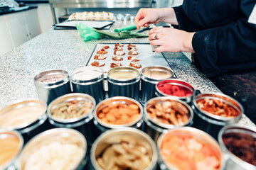 topping pastries in an artisan chocolate workshop