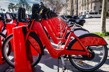 ecological red bicycles for rent. Sustainable mobility. Green transportation.