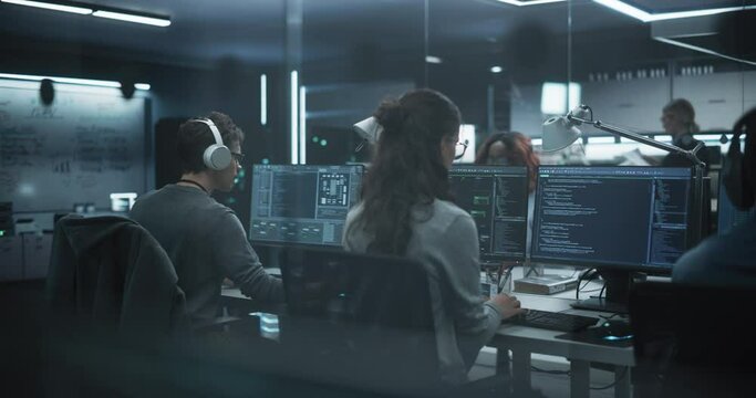 Establishing Shot: Team of Talented Young Professionals Working in a Technological Research and Development Agency. Computer Screens with Software Code and Technical Neural Network Diagrams
