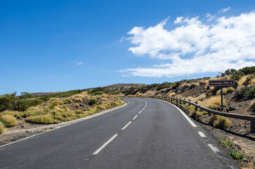 Sharp turn of the mountain road with  road sign Caramujo view point. Teide National Park, Tenerife, Canary Islands, Spain.