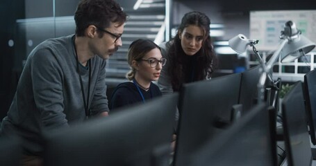 Team of Three Talented Young Software Engineers Use Computer to Discuss a Technological Project in Modern Industrial Office. Group of Male and Female Scientists Work in Research and Development Center - Powered by Adobe