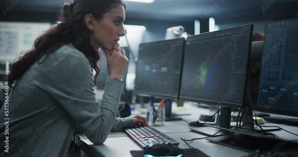 Poster Portrait of a Thoughtful Young Engineer Working on Computer in a Technological Office Environment. Beautiful Multiethnic Woman Writing Software Code for a Blockchain Project